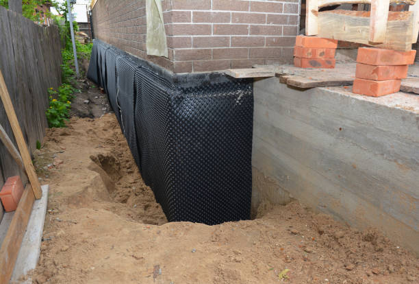 Happy homeowners after waterproofing job in Medford